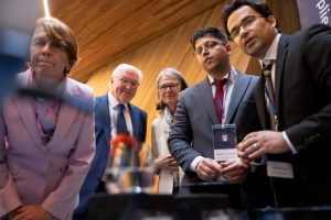 President Frank-Walter Steinmeier viewing applied science research exhibit. From left: First Lady Elke Büdenbender, President Steinmeier, UBC President Deborah Buszard, and UBC school of engineering PhD candidate Ahmad Ghaffarkhan and postdoctoral fellow Dr. Hadi Hosseini. Credit: Geoff Lister/UBC.